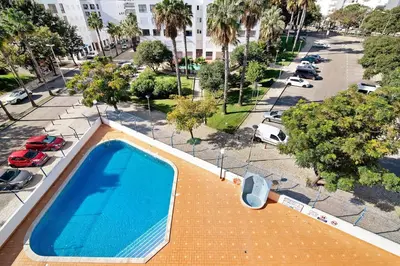 an overhead view of a swimming pool on a city street at Lovely one bedroom apartment in Quarteira
