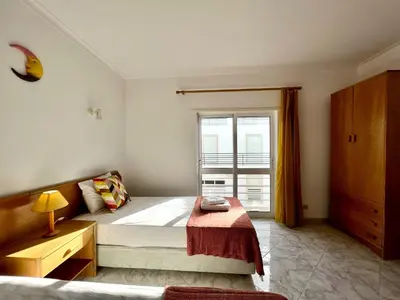 a small bedroom with a bed and a window at Albufeira Falesia Beach 4 by Homing in Albufeira