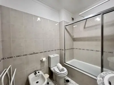 a bathroom with a toilet and a shower and a sink at Albufeira Falesia Beach 4 by Homing in Albufeira