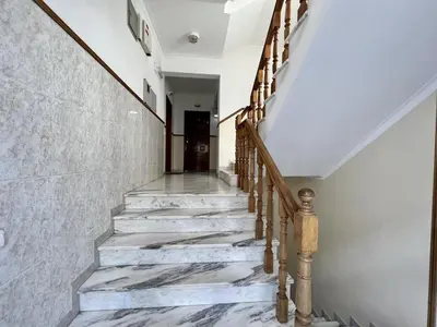 a staircase in a house with marble floors and wooden railings at Albufeira Falesia Beach 4 by Homing in Albufeira