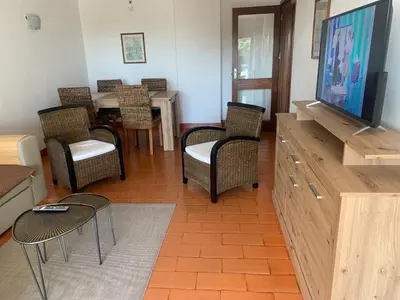 a living room with a tv and chairs and a table at Apartment 3 persons in Vilamoura, Algarve in Quarteira