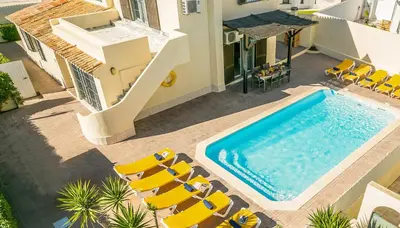 an overhead view of a swimming pool with chairs and a house at Villa Dorado by Algarve Vacation in Albufeira