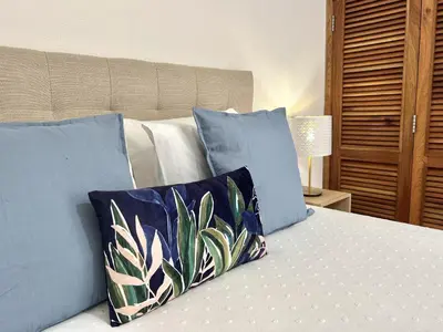 a bedroom with a bed with blue pillows at Sun II - City center by HD PROPERTIES in Vilamoura