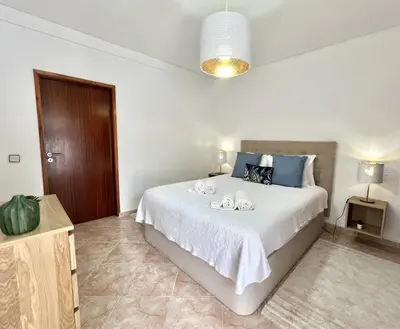 a bedroom with a bed with two towels on it at Sun II - City center by HD PROPERTIES in Vilamoura