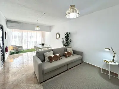 a living room with a couch and a table at Sun II - City center by HD PROPERTIES in Vilamoura