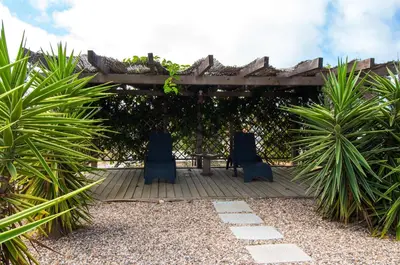 a patio with two chairs and a pergola at By the sea, Algarve in Galé