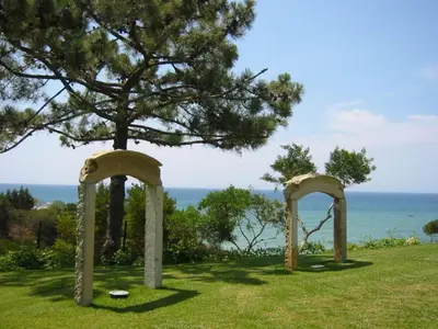 two archways in a field with a tree and the ocean at Amazing Portuguese Villa Villa Heroine 6 Bedrooms Stunning Position in Albufeira