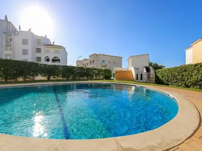 a large blue swimming pool in a courtyard with buildings at Luxury Penthouse Apartment Private Jacuzzi, Albufeira in Albufeira