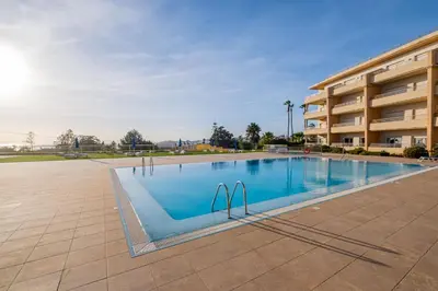 a large swimming pool in front of a building at Apartment Oura - Views of sea, Albufeira bay & Old Town in Albufeira