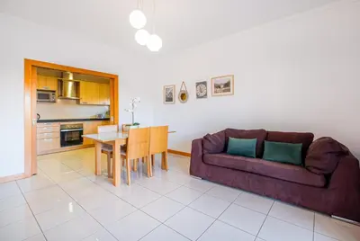 a living room with a couch and a table at Apartment Oura - Views of sea, Albufeira bay & Old Town in Albufeira