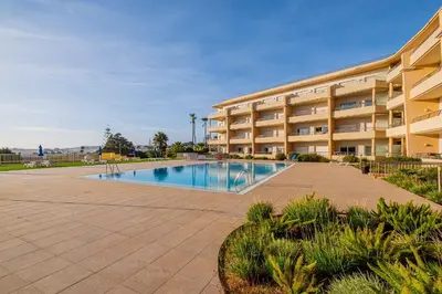 a swimming pool in front of a building at Apartment Oura - Views of sea, Albufeira bay & Old Town in Albufeira