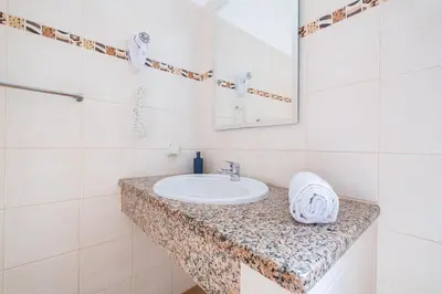 a bathroom with a sink and a mirror at Villa Amaris by Atlantic Places in Albufeira