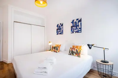 a white bedroom with two beds and a lamp at Villa Amaris by Atlantic Places in Albufeira