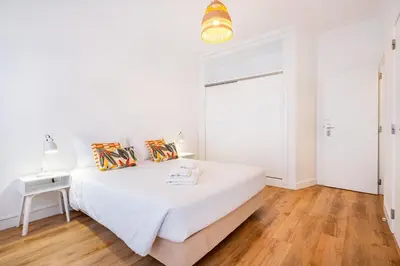 a white bedroom with a bed and a window at Villa Amaris by Atlantic Places in Albufeira