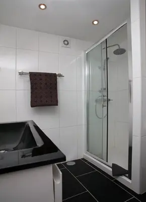 a bathroom with a sink and a glass shower at Apartment Aiko - Downtown Albufeira in Albufeira
