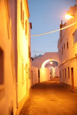 an alley way with buildings and an archway at Apartment Aiko - Downtown Albufeira in Albufeira