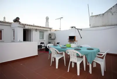 a patio with a table and chairs on a roof at Apartment Aiko - Downtown Albufeira in Albufeira