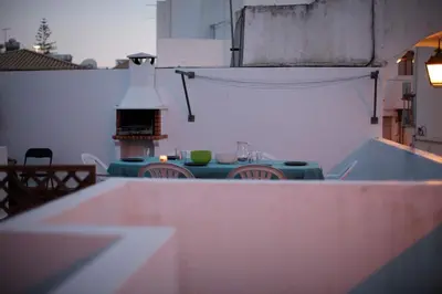 a table and chairs in an outdoor area with a tableablish at Apartment Aiko - Downtown Albufeira in Albufeira