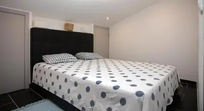 a bedroom with a large bed with polka dot sheets at Apartment Aiko - Downtown Albufeira in Albufeira