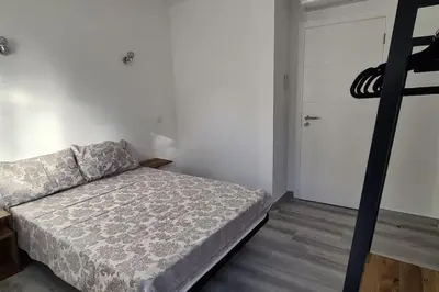 an empty room with white walls and wood floors at Villa Garden - 22 Guests - 2 Pools in Albufeira