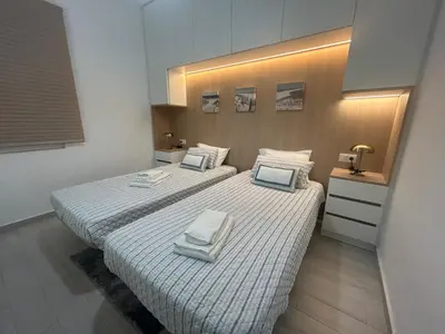 a bedroom with two beds with towels on them at Casa Garcia in Quarteira