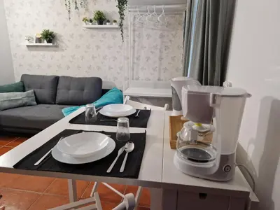 a coffee maker on a table in a living room at Paulo's 104 in Albufeira