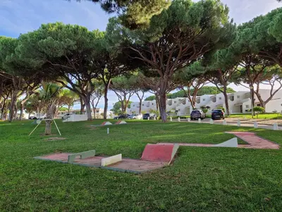 a park with a skateboard on the grass and trees at Paulo's 104 in Albufeira