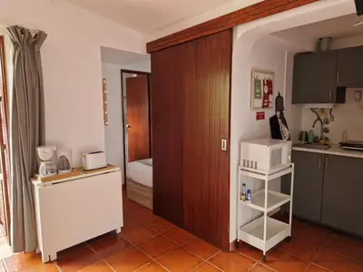 a small kitchen with a refrigerator and a microwave at Paulo's 104 in Albufeira