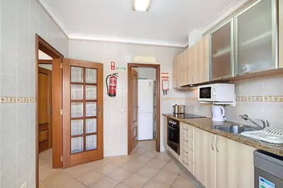a kitchen with a sink and a microwave at Villa Catarina in Albufeira