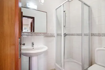 a bathroom with a sink and a shower at Villa Catarina in Albufeira