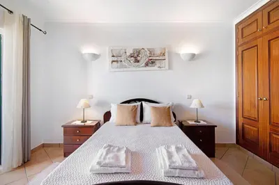 a bedroom with a bed with two towels on it at Villa Catarina in Albufeira