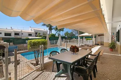 a villa with a swimming pool in front of a house at Villa Guisado in Albufeira