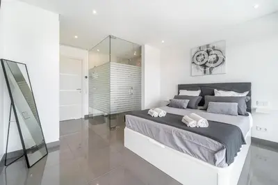 a bedroom with a large bed with two towels on it at Villa das Amendoeiras by HelloVacations in Albufeira