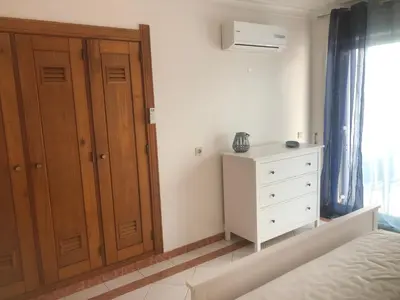 a kitchen with a microwave on top of a counter at Beachfront 2 bedroom apartment in Albufeira