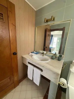 a bedroom with a bed and a door to a balcony at Beachfront 2 bedroom apartment in Albufeira