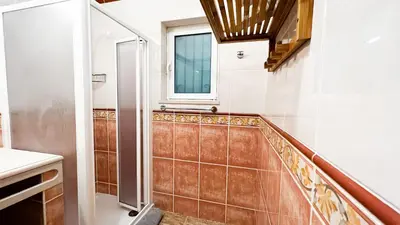 a bathroom with a walk in shower next to a window at Villa Pedro by Sunny Deluxe in Albufeira