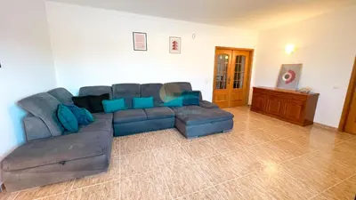 a living room with a large couch and blue pillows at Villa Pedro by Sunny Deluxe in Albufeira