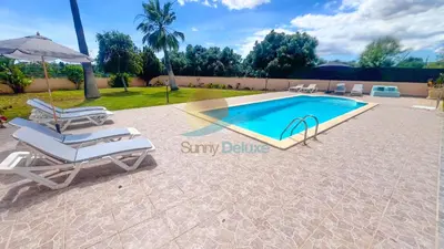 a swimming pool with two lounge chairs and an umbrella at Villa Pedro by Sunny Deluxe in Albufeira