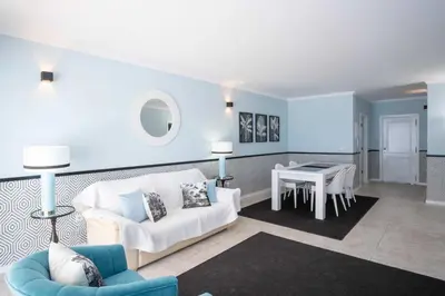 a living room with a white couch and a table at Apartment Claro Azul in Albufeira