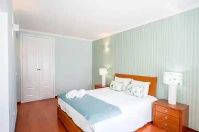 a bedroom with a large white bed with two pillows at Apartment Claro Azul in Albufeira