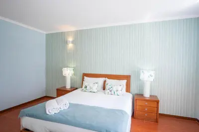 a bedroom with a large bed with two night stands at Apartment Claro Azul in Albufeira