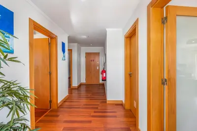 a hallway with wooden doors and wooden floors at Albufeira Corcovada Apartments in Albufeira