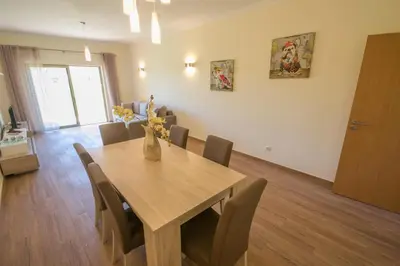 a dining room with a wooden table and chairs at Marina Jardim - Great complex for families in Albufeira