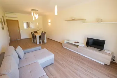 a living room with a couch and a flat screen tv at Marina Jardim - Great complex for families in Albufeira