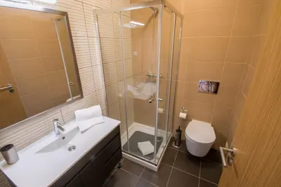 a bathroom with a shower and a sink and a toilet at Marina Jardim - Great complex for families in Albufeira