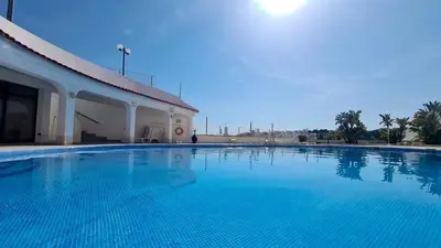 a large swimming pool next to a building at Albufeira, Modern Sea View Home 33 in Albufeira