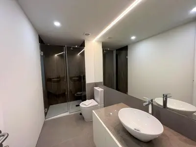 a bathroom with a sink and a toilet and a shower at Faro Design 5 by Homing in Faro