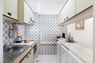 a kitchen with a sink and a counter top at Apartamento AnaMar by Sunnyway in Albufeira