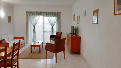 a living room with a couch and a table at Apartamento AnaMar by Sunnyway in Albufeira