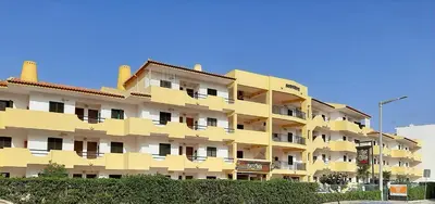 a yellow apartment building with balconies at Apartamento AnaMar by Sunnyway in Albufeira